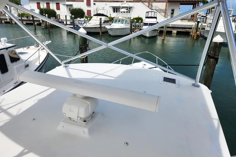 Slide: The Image of 1987 Young Brothers Custom Sport Fish boat docked at marina, featuring radar equipment. - 30