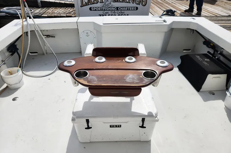 Slide: The Image of 1987 Young Brothers Custom Sport Fish boat deck with fishing chair and YETI cooler. - 32