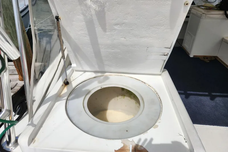 Slide: The Image of Open hatch on 1987 Young Brothers Custom Sport Fish boat, revealing storage compartment. - 33
