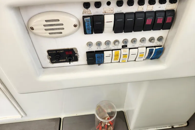 Slide: The Image of Control panel of a 1987 Young Brothers Custom Sport Fish boat with switches and bilge pump. - 9
