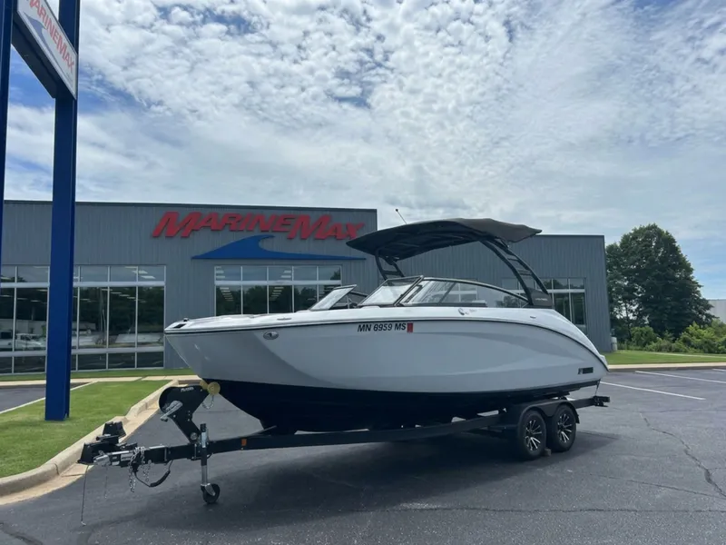 Slide: The Image of A 2025 Yamaha 252SD boat on a trailer in front of a MarineMax building. - 0