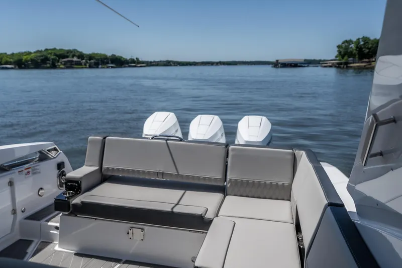 Slide: The Image of Luxury seating on a 2027 Monterey 385SS Super Sport boat with scenic lake view. - 12
