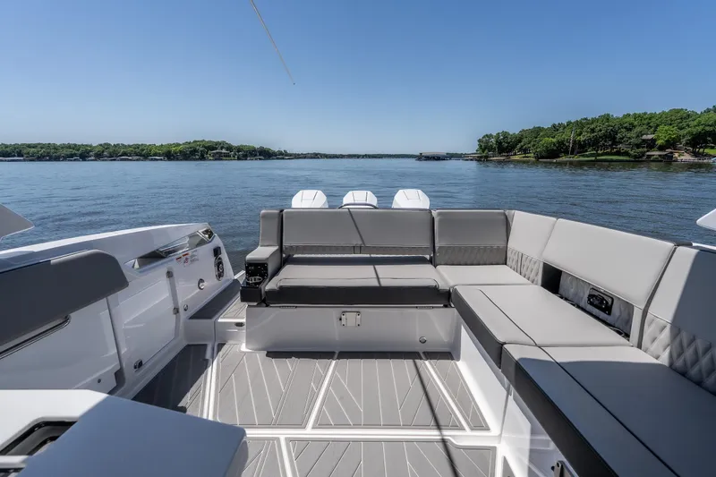 Slide: The Image of Luxurious 2027 Monterey 385SS Super Sport boat interior with spacious seating on a serene lake. - 13