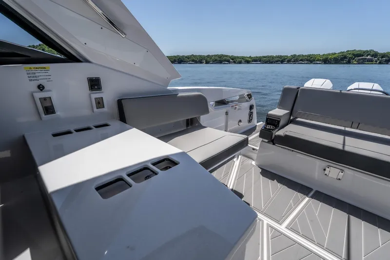 Slide: The Image of Interior of 2027 Monterey 385SS Super Sport boat with sleek seating and lake view. - 14