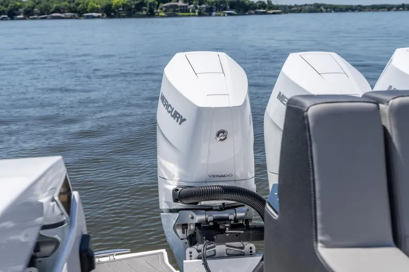 Slide: The Image of 2027 Monterey 385SS Super Sport boat with Mercury Verado engines on a serene lake. - 16