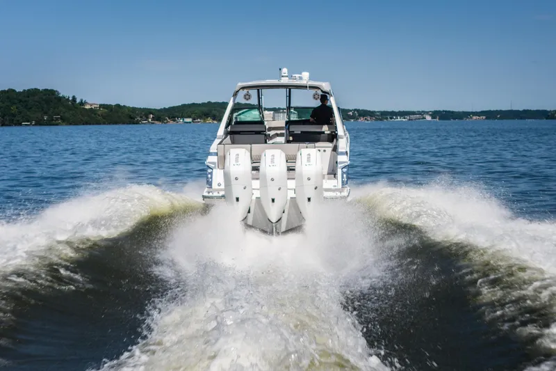 Slide: The Image of 2027 Monterey 385SS Super Sport boat cruising on a lake, creating a dynamic wake. - 2