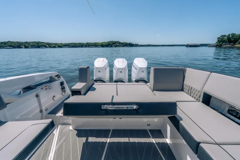 Slide: The Image of 2027 Monterey 385SS Super Sport boat interior with luxurious seating on a serene lake. - 21