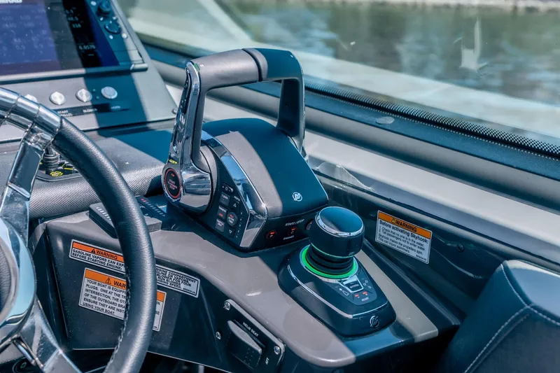 Slide: The Image of Control panel of 2027 Monterey 385SS Super Sport boat with steering and throttle. - 24