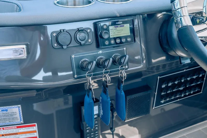 Slide: The Image of Control panel of 2027 Monterey 385SS Super Sport boat with keys and audio system. - 27