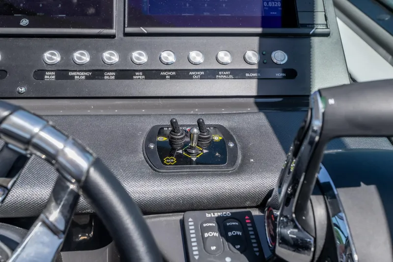 Slide: The Image of Control panel of a 2027 Monterey 385SS Super Sport boat with various switches and joystick. - 30