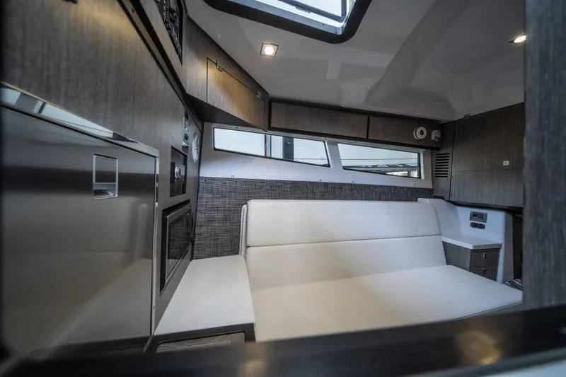 Slide: The Image of Interior of 2027 Monterey 385SS Super Sport boat, featuring modern seating and sleek cabinetry. - 35
