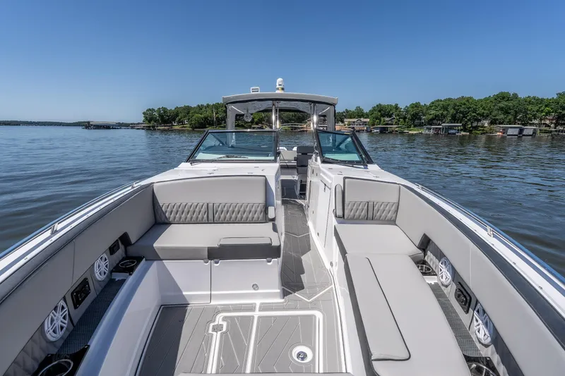 Slide: The Image of 2027 Monterey 385SS Super Sport boat with spacious seating on a serene lake. - 46