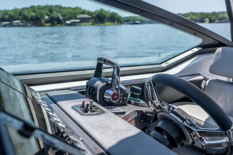 Slide: The Image of Cockpit view of 2027 Monterey 385SS Super Sport boat on a lake. - 51