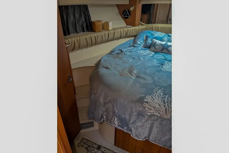 Slide: The Image of Interior of a 2004 Meridian 411 Sedan yacht, bedroom with blue bedding. - 24