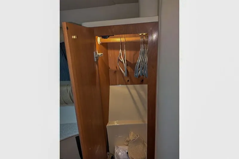 Slide: The Image of Open closet in Meridian 411 Sedan boat, year 2004. - 27
