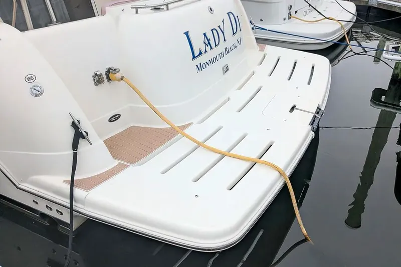 Slide: The Image of Stern of a 2004 Meridian 411 Sedan boat at dock. - 3