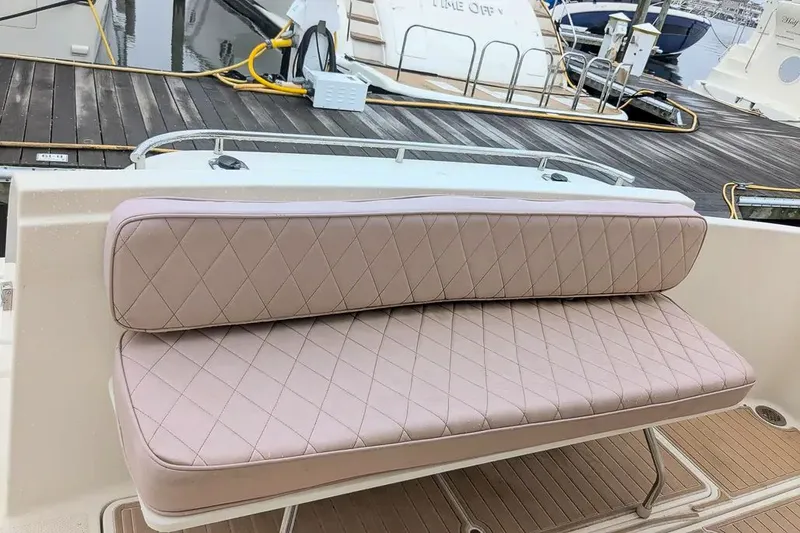 Slide: The Image of Meridian 411 Sedan 2004 with cushioned seat at dock. - 4