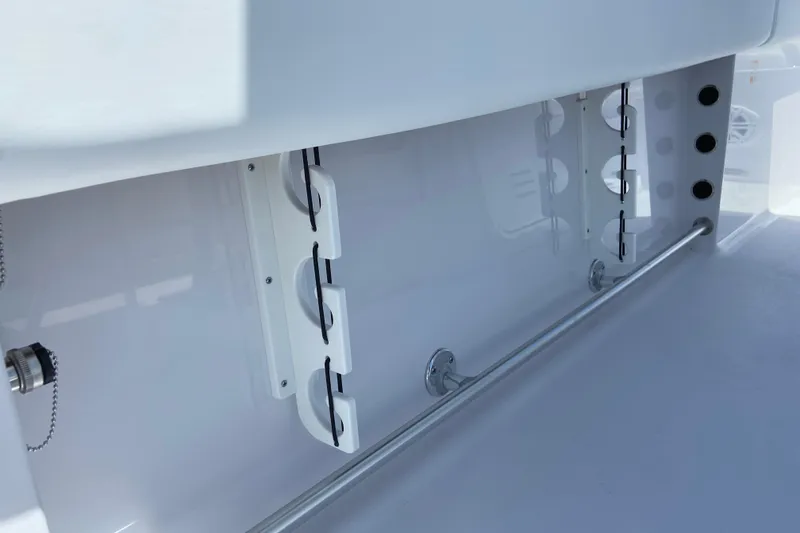 Slide: The Image of Interior view of 2026 Sportsman Heritage 231 Center Console boat, showcasing rod holders and storage. - 14