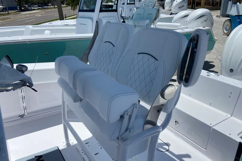 Slide: The Image of 2026 Sportsman Heritage 231 Center Console boat with white cushioned seating. - 16