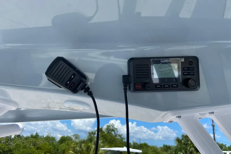 Slide: The Image of Garmin marine radio and microphone on 2026 Sportsman Heritage 231 Center Console boat. - 21