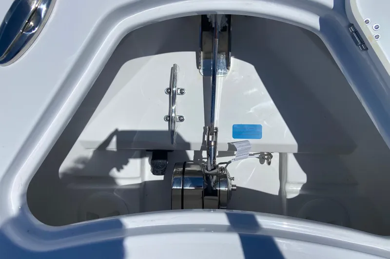 Slide: The Image of Anchor compartment of 2026 Sportsman Heritage 231 Center Console boat, featuring stainless steel fittings. - 29