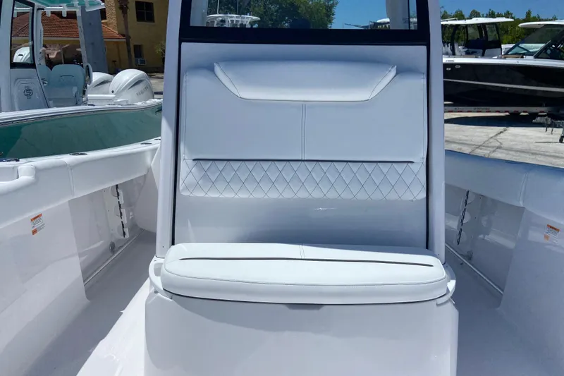 Slide: The Image of 2026 Sportsman Heritage 231 Center Console boat interior with white seating and sleek design. - 34