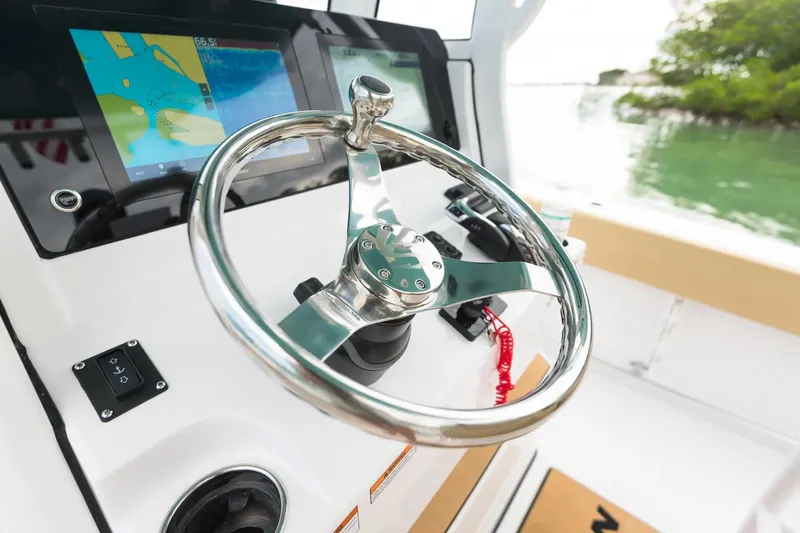 Slide: The Image of Manufacturer Provided Image: 2025 Sportsman Heritage 231 Center Console steering wheel and navigation display. - 7