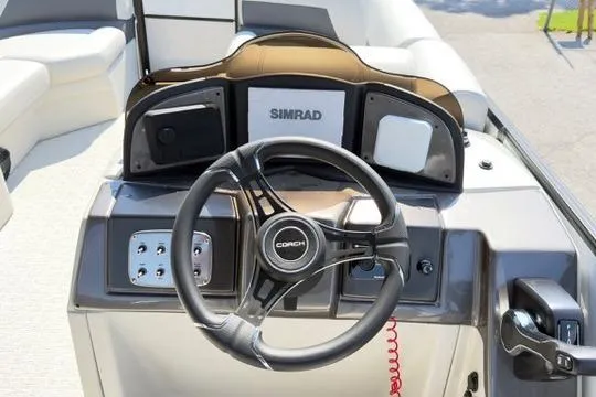 Slide: The Image of Steering console of 2026 Coach Pontoons 223 RFC with Simrad display and controls. - 18