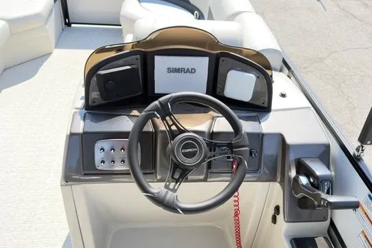 Slide: The Image of Steering console of 2026 Coach Pontoons 223 RFC with Simrad electronics and modern controls. - 17
