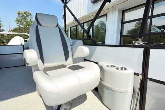 Slide: The Image of Luxurious seating on 2026 Coach Pontoons 223 RFC with cup holders, outdoor setting. - 16