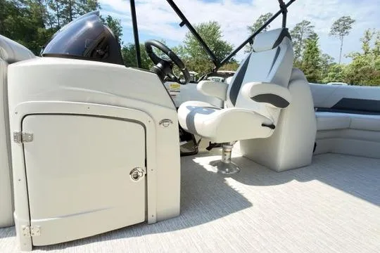 Slide: The Image of 2026 Coach Pontoons 223 RFC interior with captain's chair and control panel. - 13