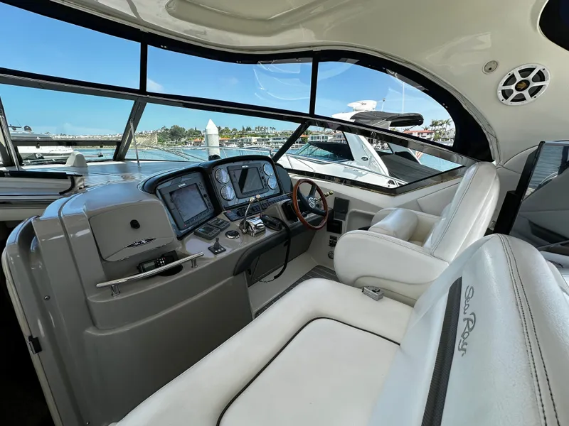 Slide: The Image of The cockpit of a 2006 Sea Ray 380 Sundancer with modern instruments and comfortable seating. - 10