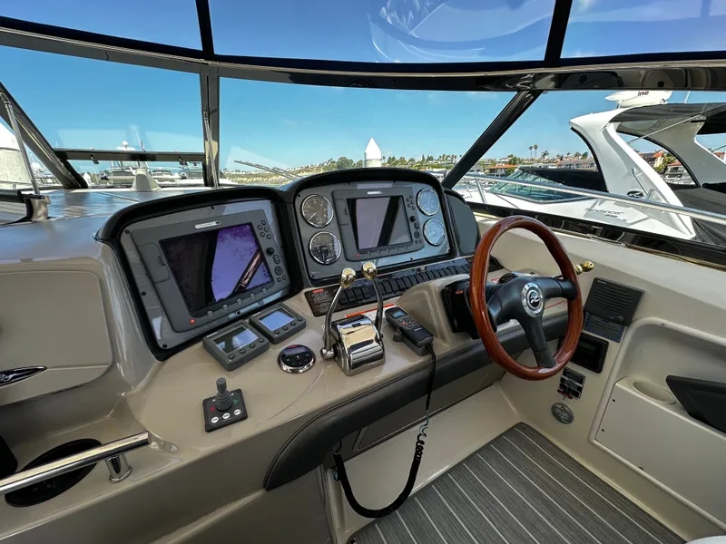 Slide: The Image of The cockpit of a 2006 Sea Ray 380 Sundancer with modern navigation equipment. - 11