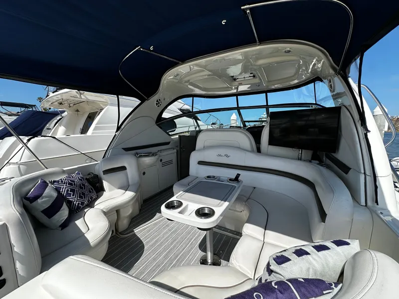 Slide: The Image of The image shows the cockpit of a 2006 Sea Ray 380 Sundancer with luxurious seating and a table. - 13