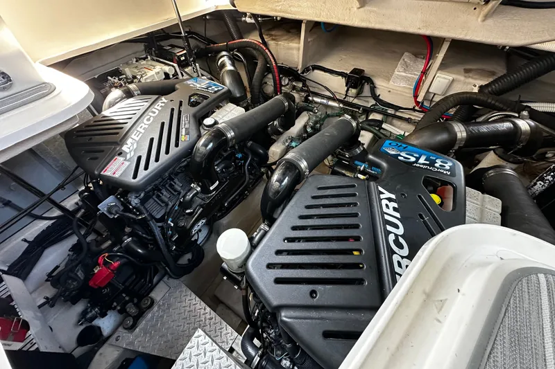 Slide: The Image of The engine room of a 2006 Sea Ray 380 Sundancer features two Mercury engines with black covers. - 29