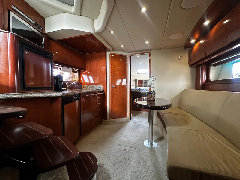 Slide: The Image of Interior of a Sea Ray 380 Sundancer yacht with elegant wood finishes and a cozy seating area. - 17