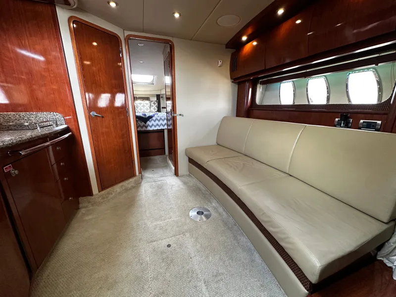 Slide: The Image of Interior of a Sea Ray 380 Sundancer with leather sofa and wooden cabinetry. - 21