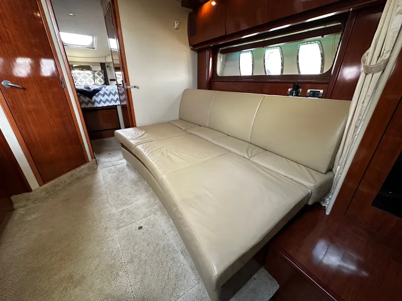 Slide: The Image of Interior of a Sea Ray 380 Sundancer with beige sofa and wooden furnishings. - 22