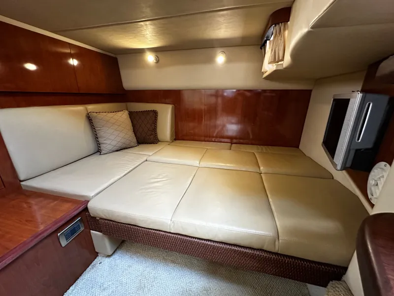 Slide: The Image of Interior of a Sea Ray 380 Sundancer with beige sofa and wooden walls. - 23