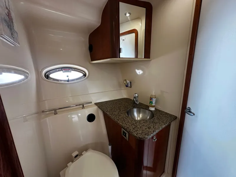 Slide: The Image of A boat bathroom with a sink, toilet, and mirror. - 25