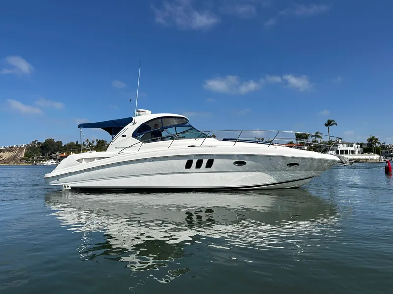 Slide: The Image of A white motorboat on calm water with a blue sky in the background. - 7