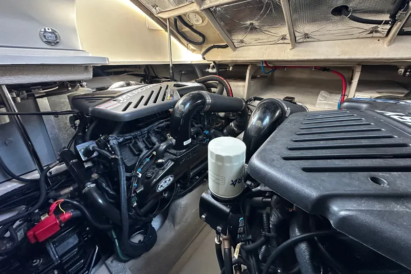 Slide: The Image of The engine room of a 2006 Sea Ray 380 Sundancer with two large engines and various components. - 28
