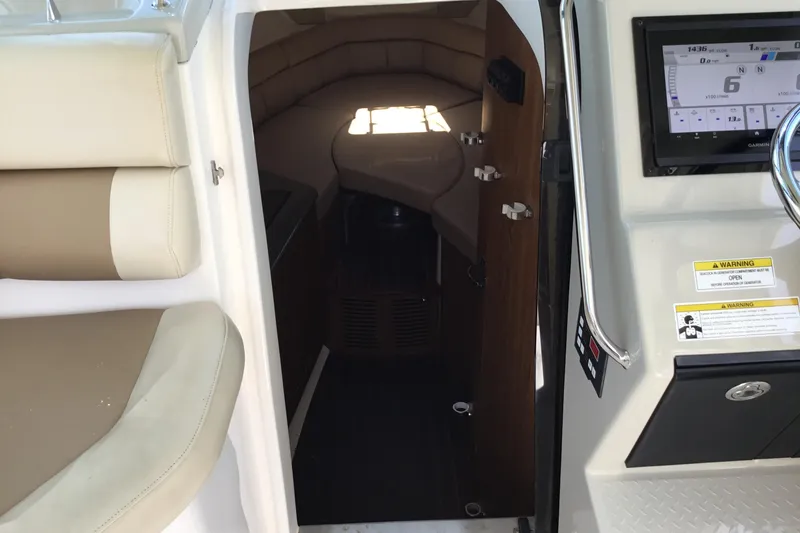 Slide: The Image of Interior cabin view of 2013 Everglades 320EX boat with seating and control panel. - 46