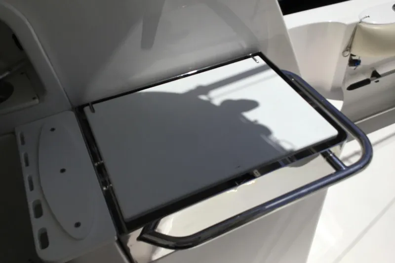 Slide: The Image of 2013 Everglades 320EX boat interior with foldable table and stainless steel frame. - 22
