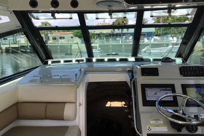 Slide: The Image of Interior view of 2013 Everglades 320EX boat cockpit with steering wheel and navigation system. - 29