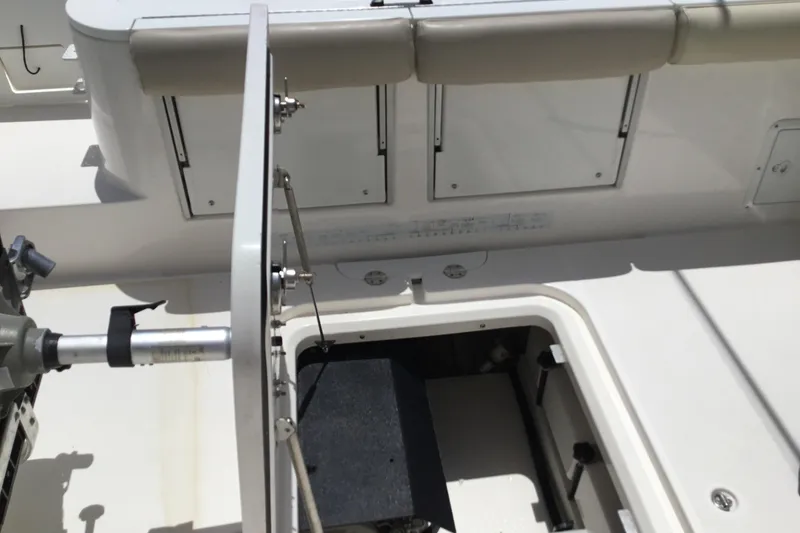 Slide: The Image of 2013 Everglades 320EX boat interior with storage compartments and fishing equipment. - 39