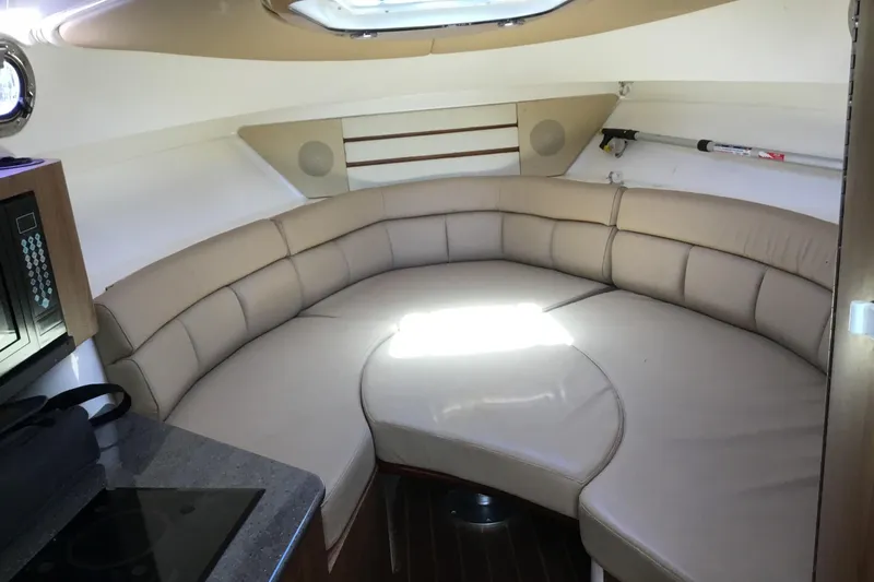 Slide: The Image of Interior of 2013 Everglades 320EX boat with beige leather seating and modern amenities. - 47