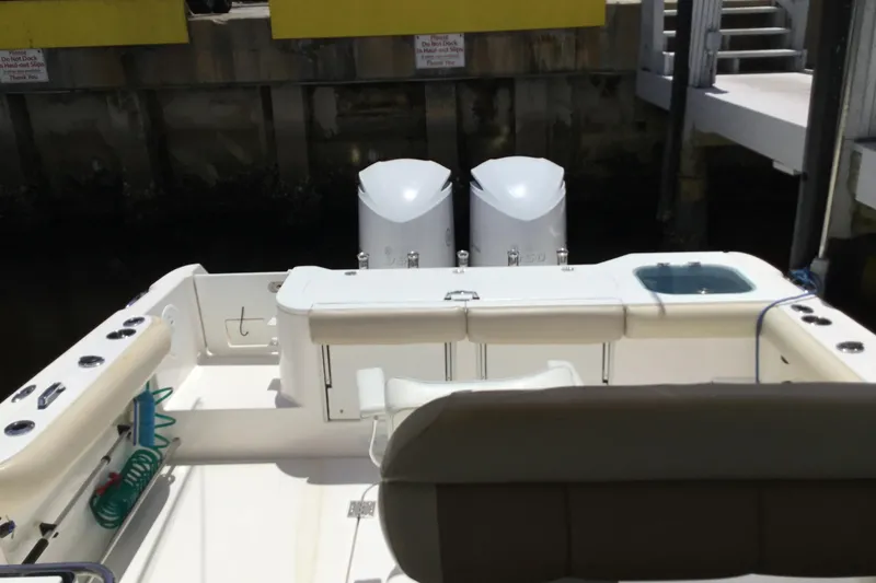Slide: The Image of 2013 Everglades 320EX boat interior with dual engines at dock. - 21