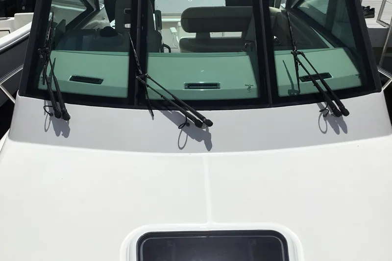 Slide: The Image of 2013 Everglades 320EX boat windshield with wipers, showcasing sleek design and functionality. - 14