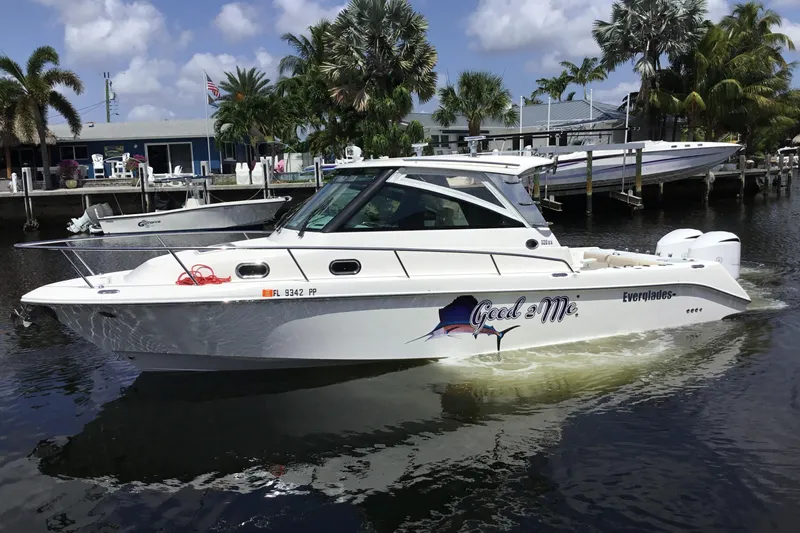 Slide: The Image of 2013 Everglades 320EX boat docked, featuring sleek design and vibrant graphics. - 7